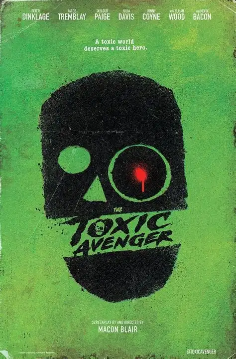 A movie poster for 'The Toxic Avenger' features a stylized black skull with one glowing red eye and a green background. The…