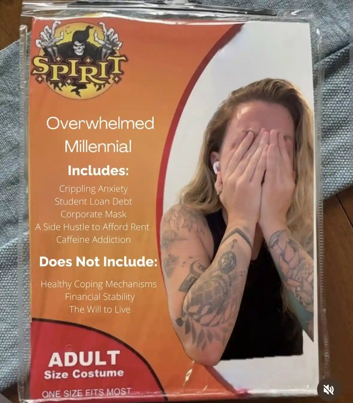 An image of a Halloween costume package labeled 'Overwhelmed Millennial' with a photo of a person with tattoos covering…