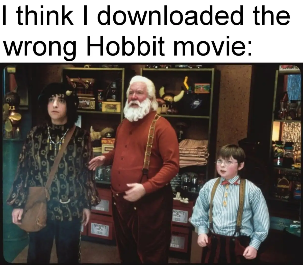 Three characters from the movie 'The Hobbit' stand in a cluttered shop, looking confused and bewildered. The central figure…