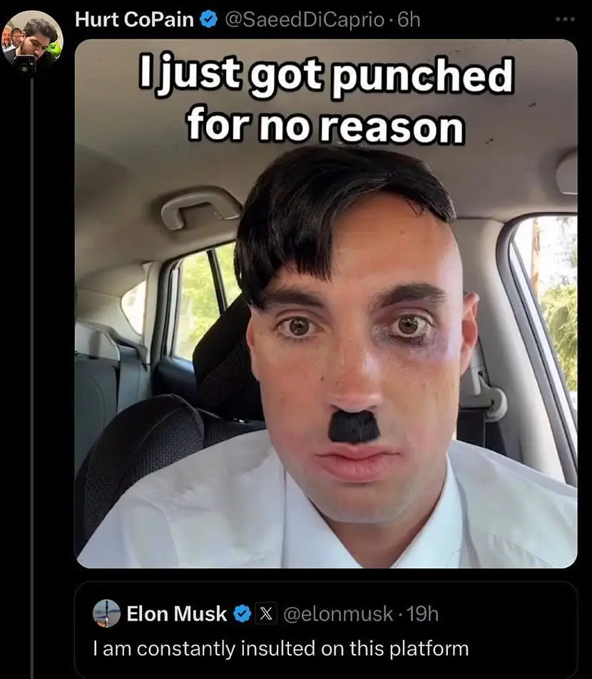 A man with a black mustache and a bruised left eye sits in a car, looking directly at the camera. The text overlay reads 'I…