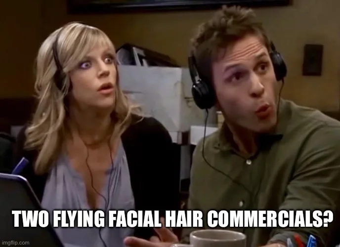 A man and a woman wearing headphones sit side by side, both looking shocked and confused. The man has his mouth slightly…