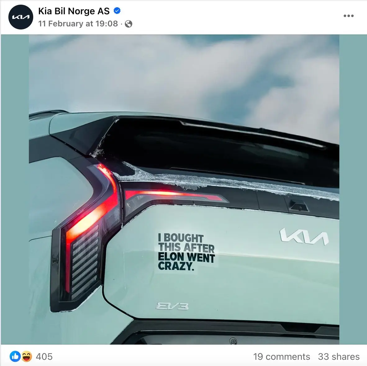 A light green Kia EV3 electric car is shown from the rear, with frost or ice along the top edge of the tailgate and a red…