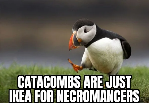 A puffin stands on grass, looking down at its orange beak and feet, with bold white text overlaid that reads 'CATACOMBS ARE…