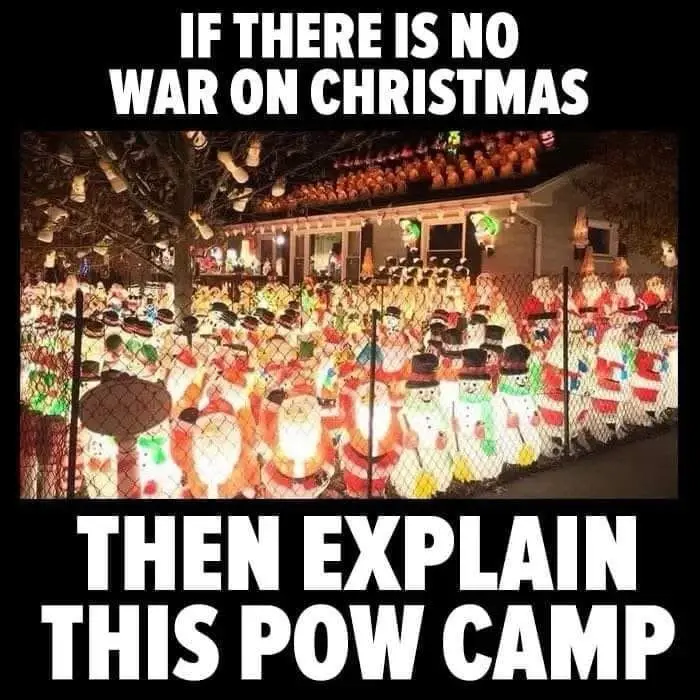 An outdoor nighttime photo shows a chain-link fence enclosing a dense crowd of illuminated plastic Christmas decorations…