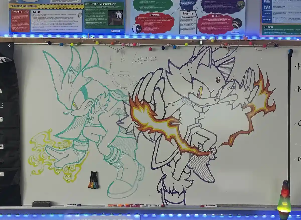 A whiteboard in a classroom displays two large, partially colored drawings of the video game character Sonic the Hedgehog…