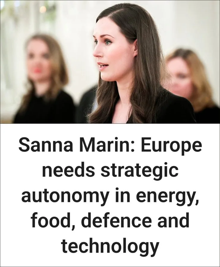 A photo of Finnish Prime Minister Sanna Marin looking serious and slightly surprised, with two blurred women behind her. The…