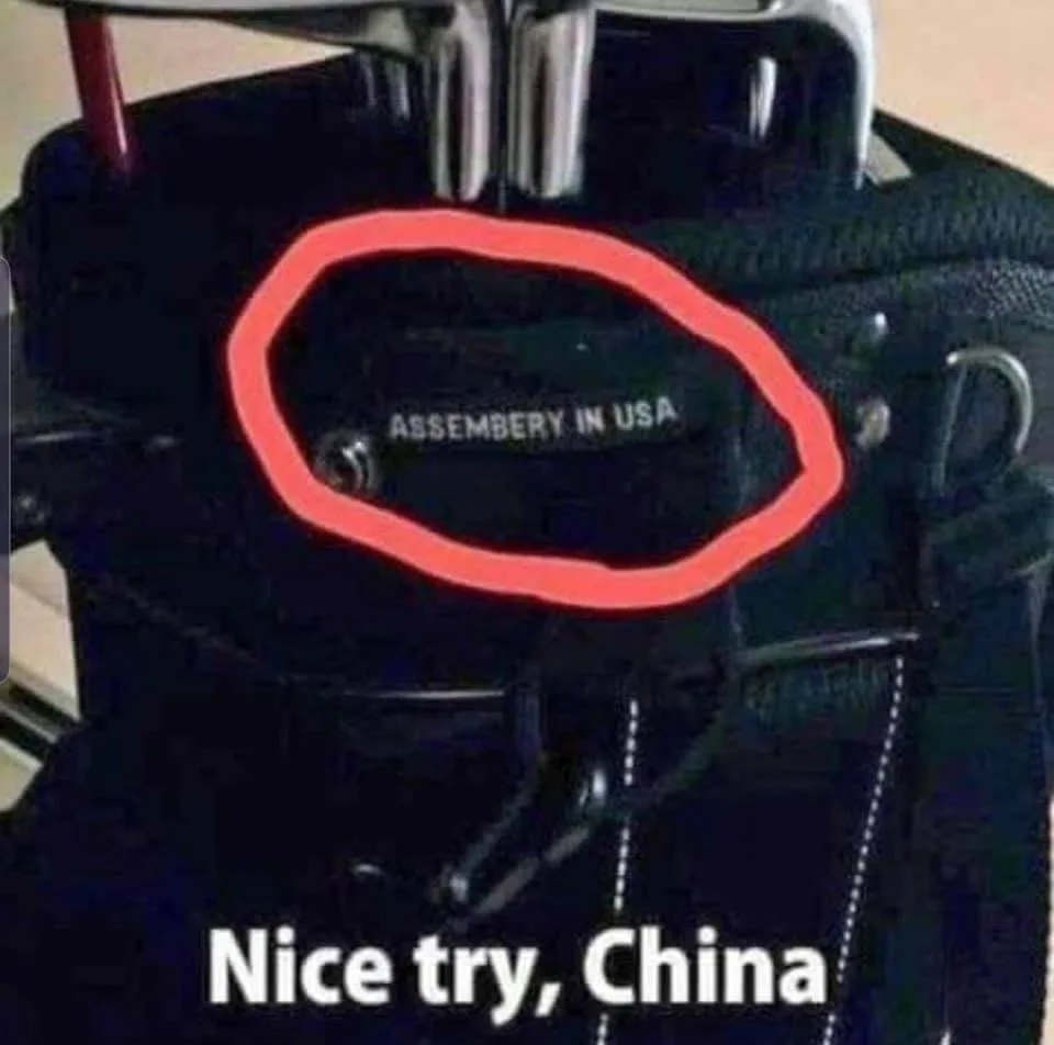 A close-up of a black golf bag with a red circle highlighting a small tag that reads 'ASSEMBERY IN USA'. Below the image…