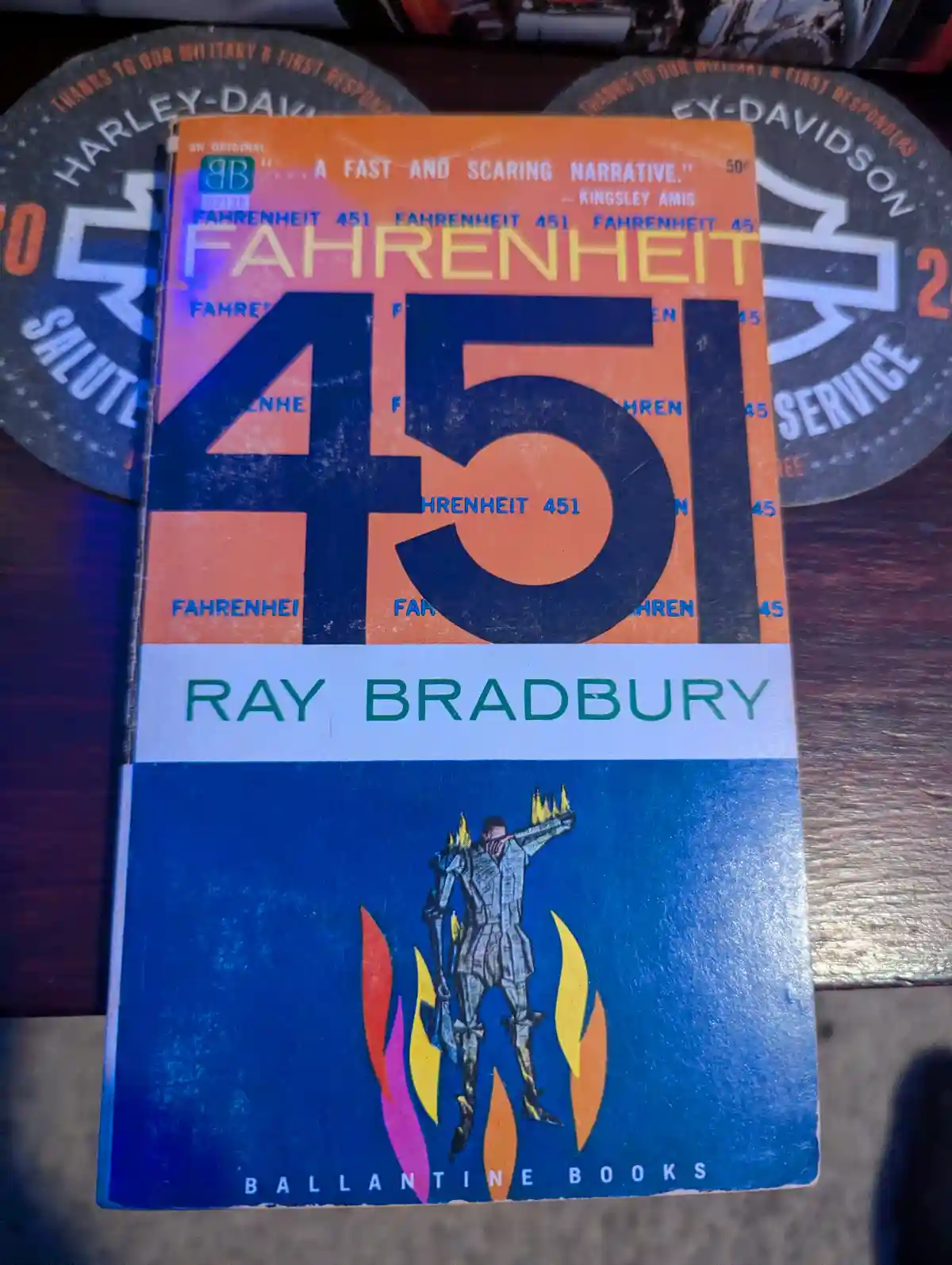 A close-up photo of a vintage paperback copy of Ray Bradbury's 'Fahrenheit 451' by Ballantine Books, featuring its iconic…