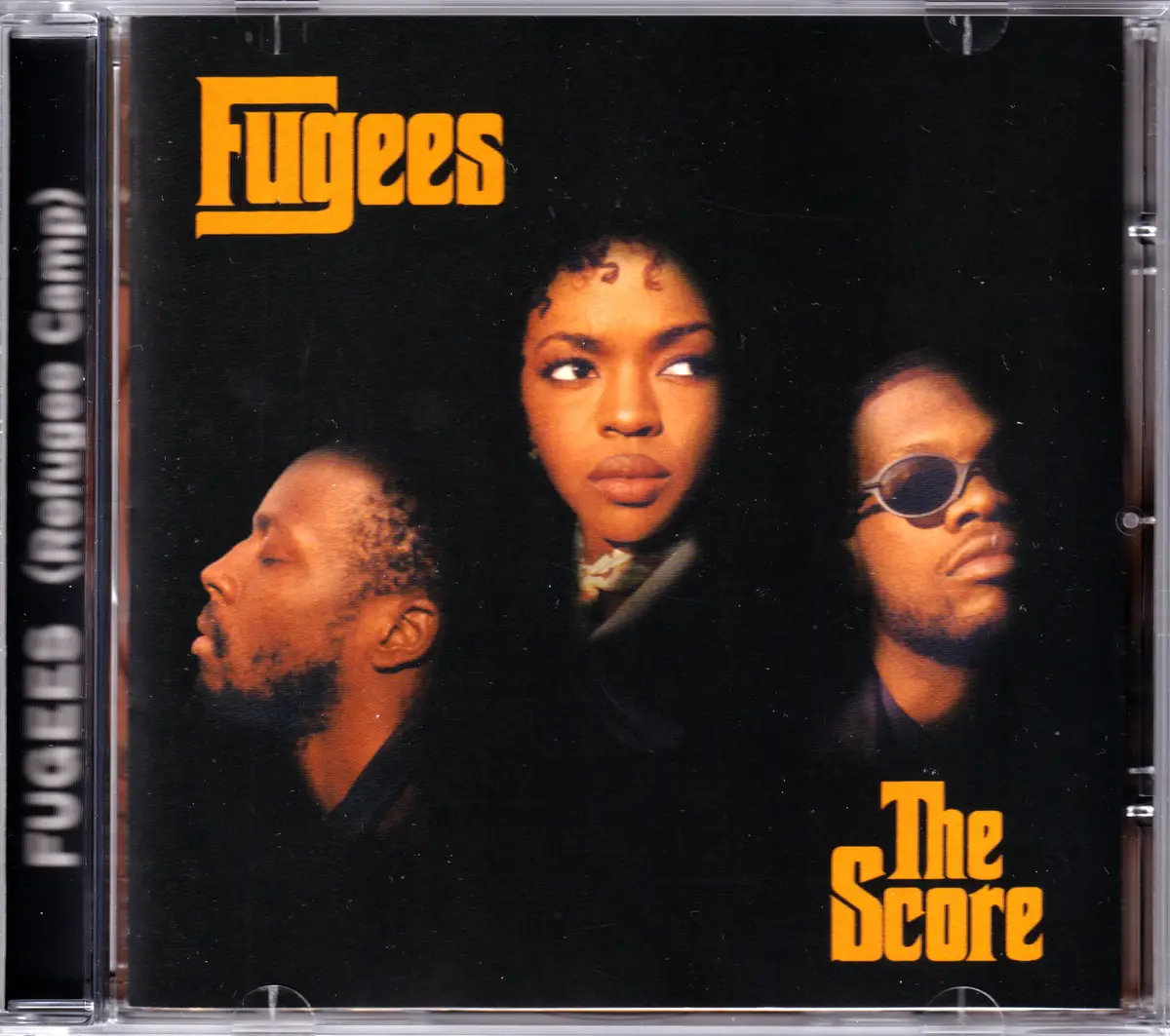 The image shows the cover of the Fugees' 1996 album 'The Score', featuring the three band members against a black…