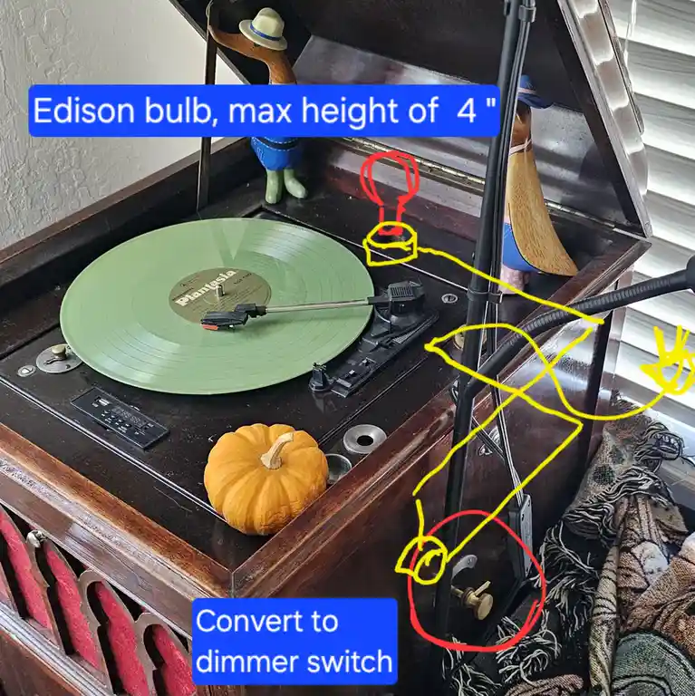 A vintage wooden record player with a green vinyl record spinning, a small pumpkin on the platter, and two wooden duck…