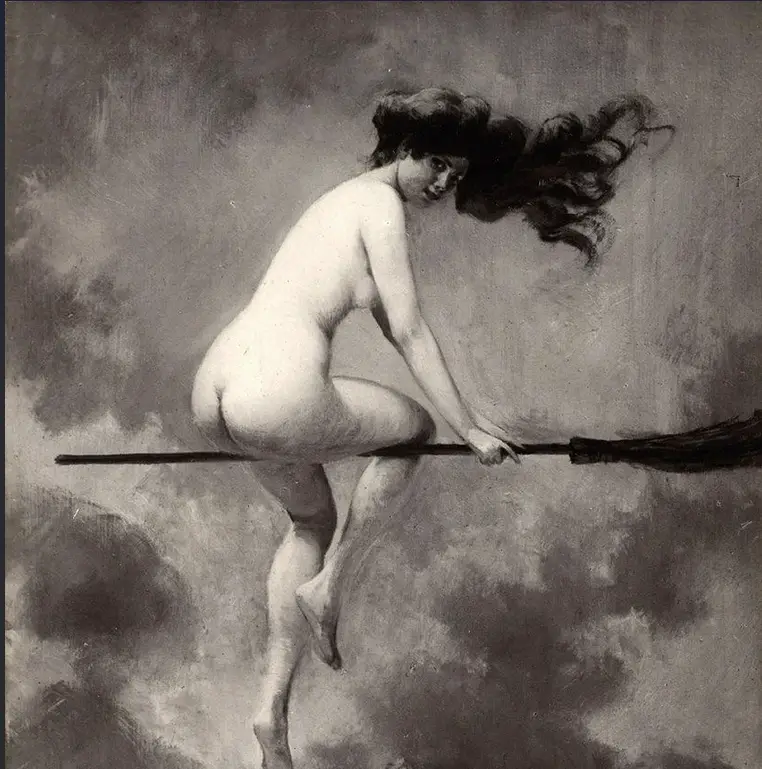 A black-and-white painting depicts a nude woman with flowing dark hair riding a broomstick through cloudy skies, looking…