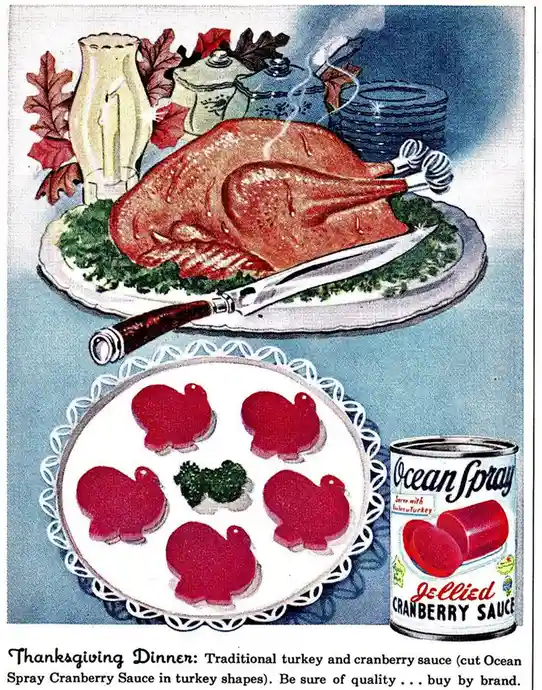 A vintage advertisement depicts a Thanksgiving dinner with a roasted turkey on a platter and a plate of cranberry sauce…