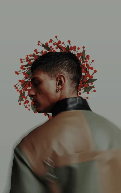 A person with short dark hair is shown in profile, wearing a black choker and a muted green top. Red berries and green…