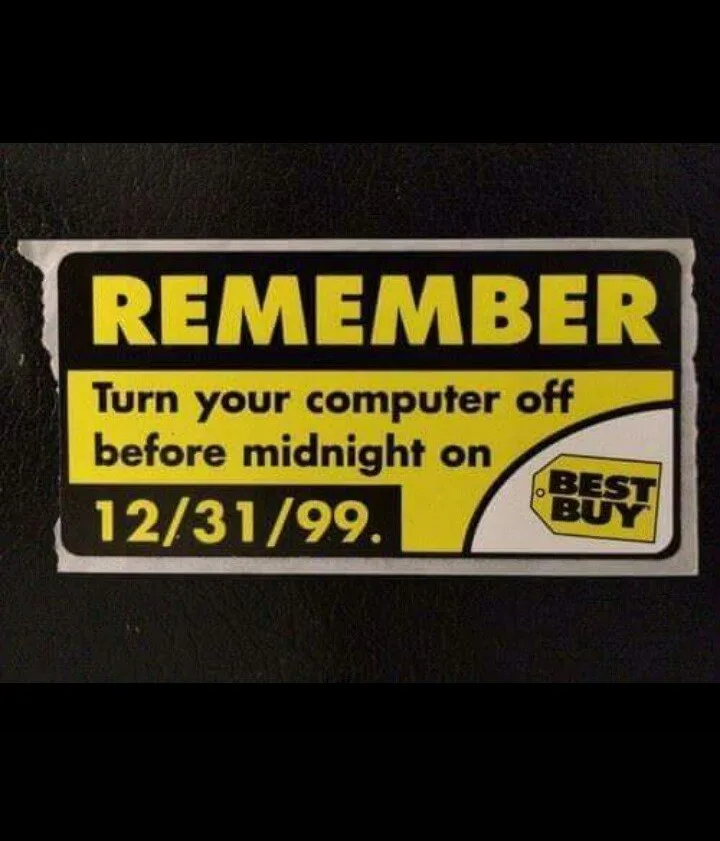 A torn Best Buy sticker with bold yellow text on a black background instructs users to 'REMEMBER Turn your computer off…