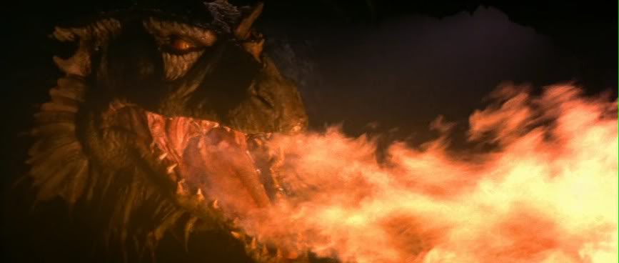 A close-up shot of a large, dark, scaly dragon with glowing orange eyes, roaring and exhaling a massive stream of bright…