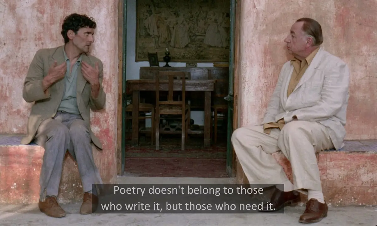 Two men sit on stone ledges facing each other in a rustic doorway; the man on the left gestures passionately while the man…