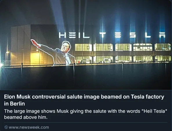 A large projection on a Tesla factory building in Berlin shows Elon Musk giving a controversial salute gesture. Above him…