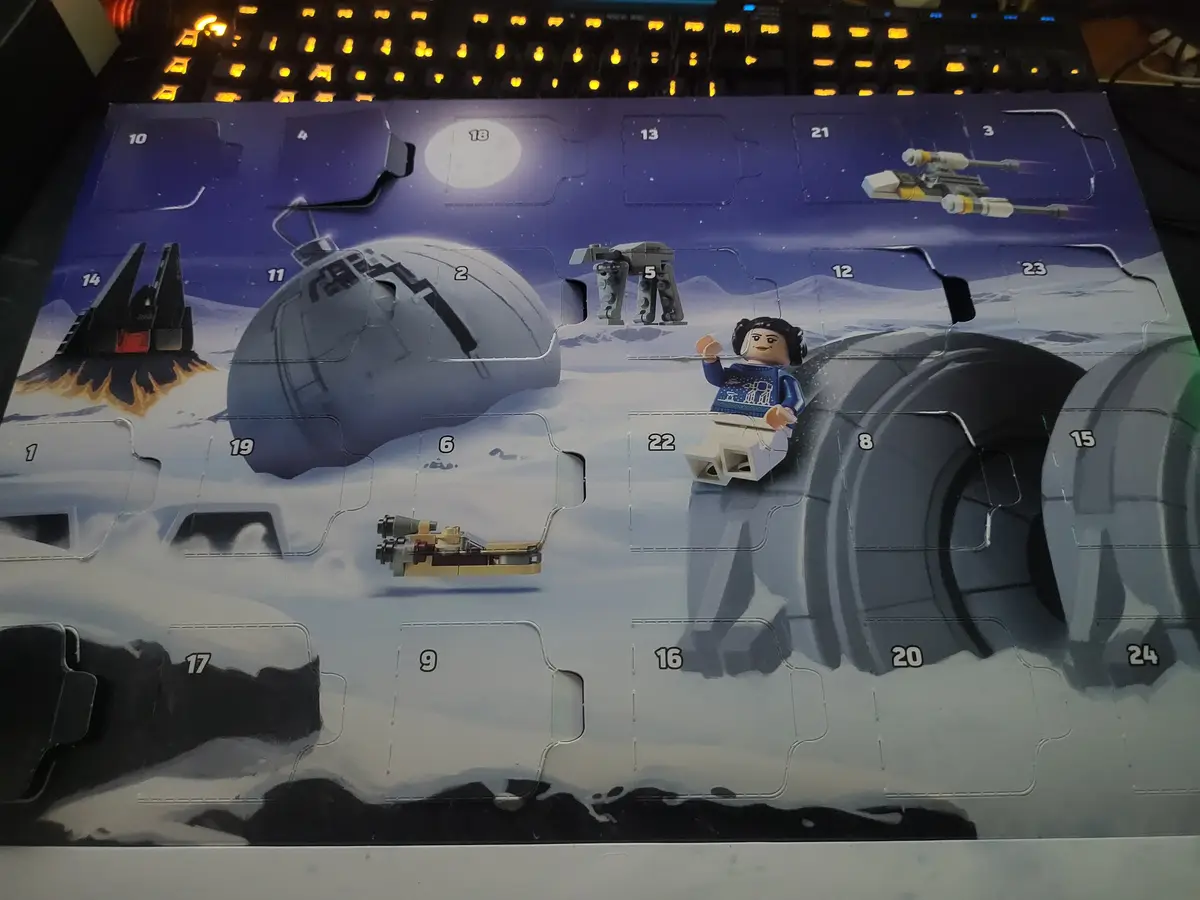 A Lego Star Wars Advent calendar with a snowy Hoth scene, featuring numbered doors (some open) revealing Star Wars…