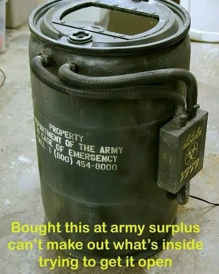 A green, military-style barrel labeled 'PROPERTY OF THE ARMY' with a 'DANGER BIOHAZARD' box attached and hoses connected…