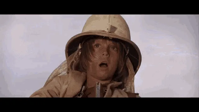 A three-panel image strip from the movie 'The Long Kiss Goodnight' shows a woman in a safari-style hat and coat looking…