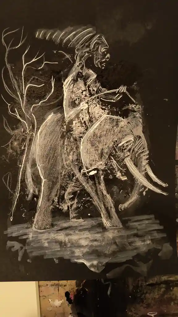 A chalk drawing on a dark surface depicts a person riding an elephant, with the rider holding reins and the elephant's tusks…