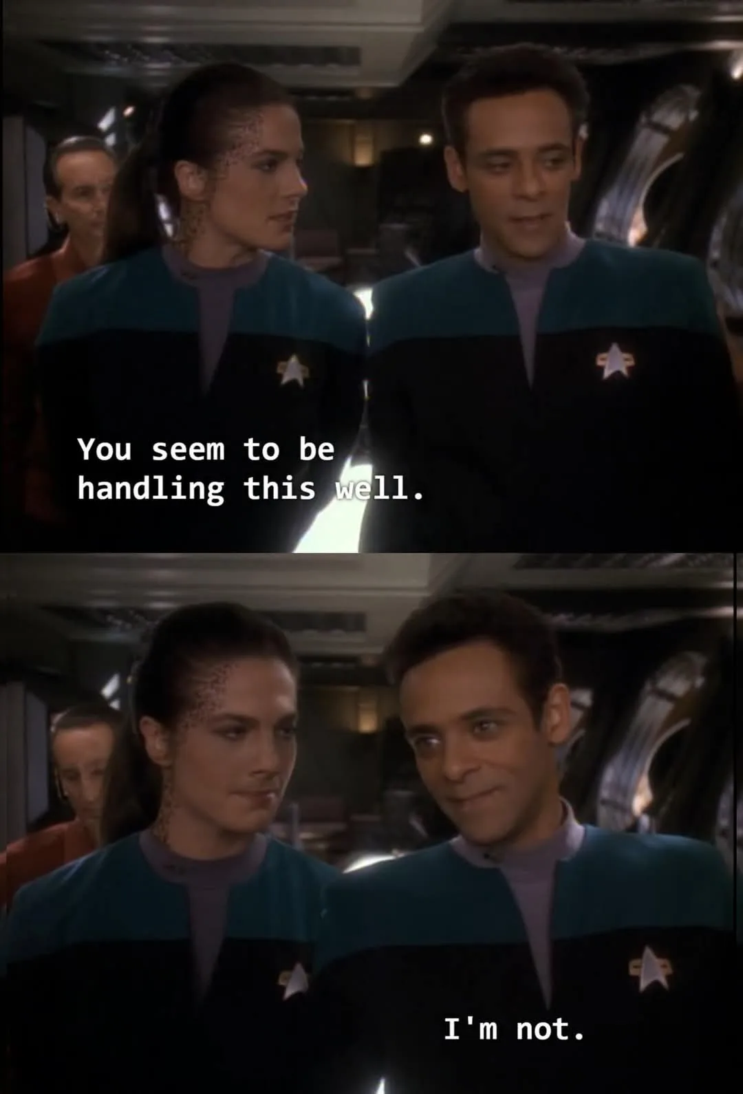 Two Starfleet officers in blue uniforms stand side by side in a spaceship corridor. The top panel shows the woman looking at…