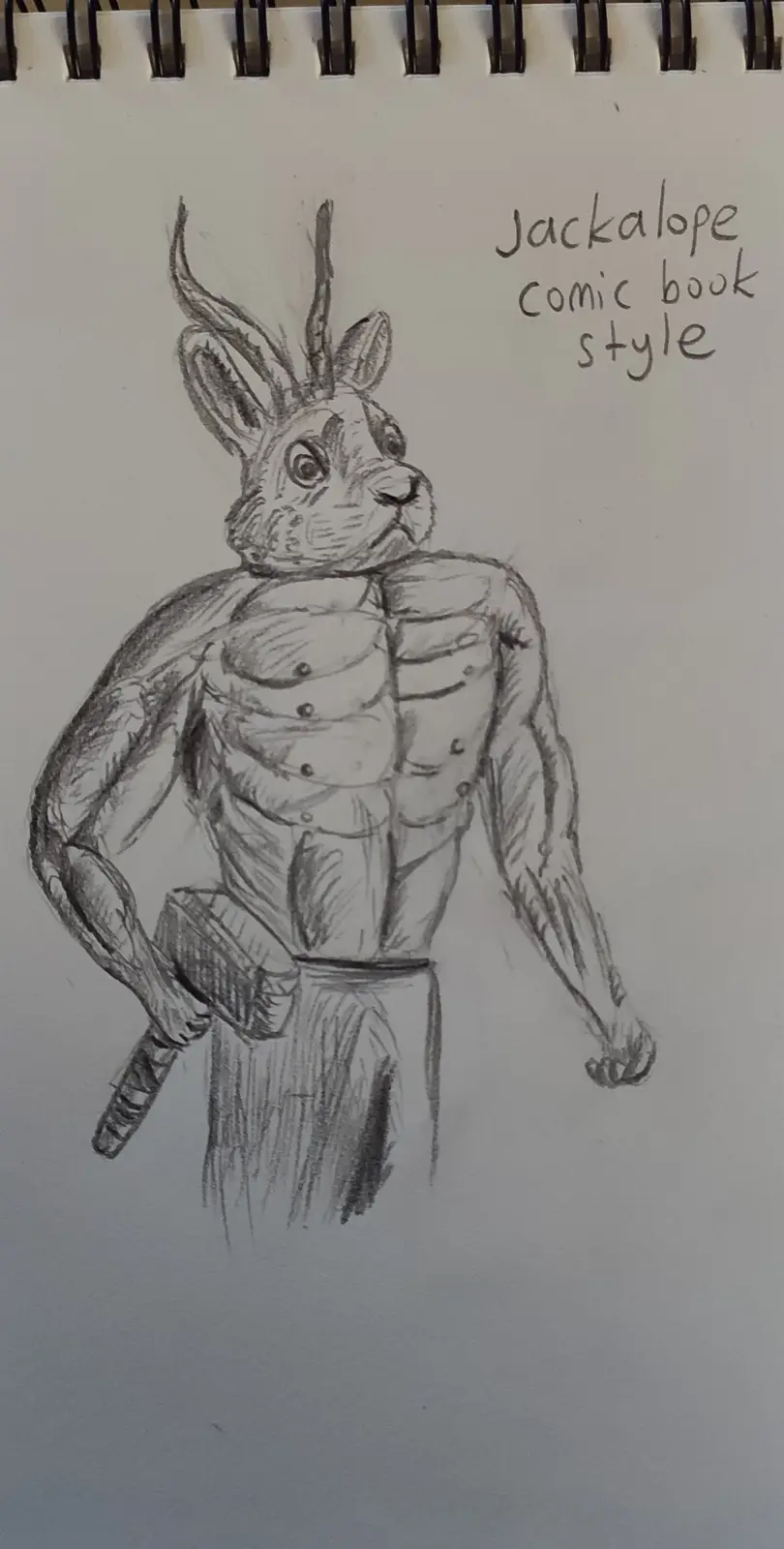 A pencil sketch on spiral-bound notebook paper depicts a muscular, anthropomorphic jackalope with antlers, wearing pants and…