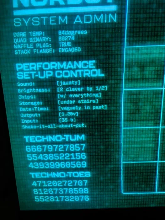 A green-tinted computer screen displays a fictional 'SYSTEM ADMIN' interface with absurd technical specs like 'WAFFLE PLUG…