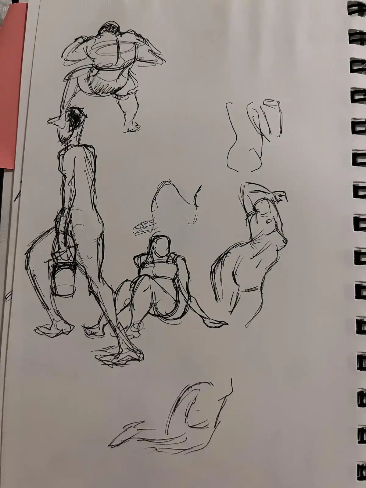 A sketchbook page filled with rough, expressive black ink drawings of human figures in various poses—standing, sitting…