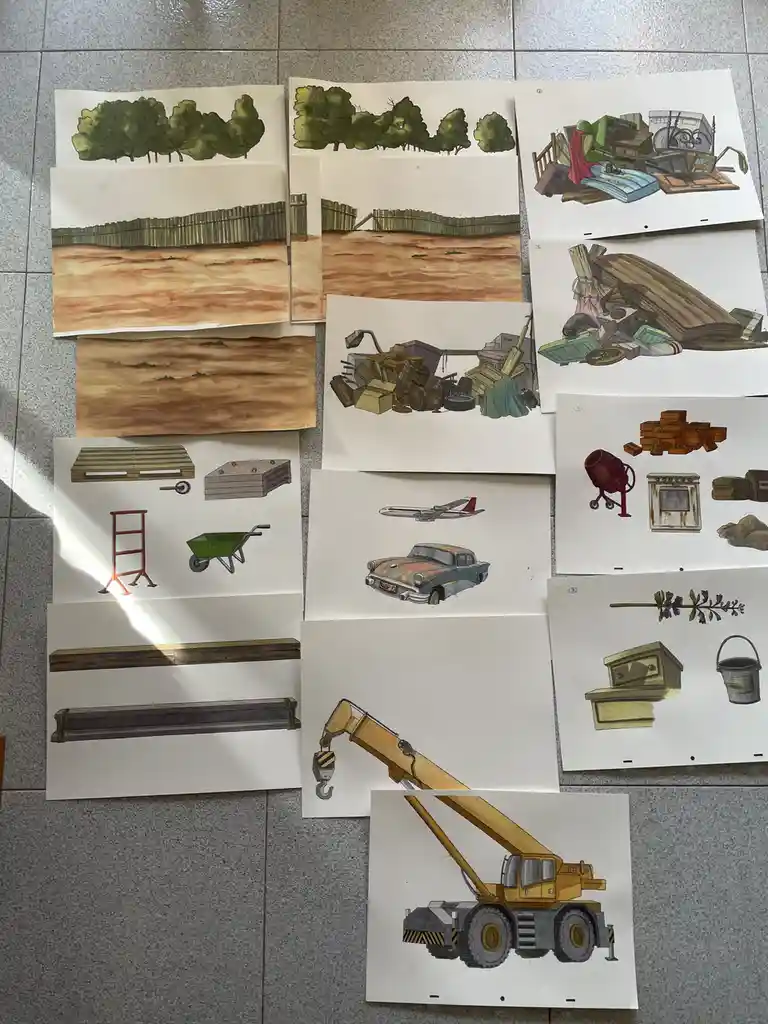 Multiple watercolor illustrations on paper are laid out on a tiled floor, depicting various scenes and objects including…