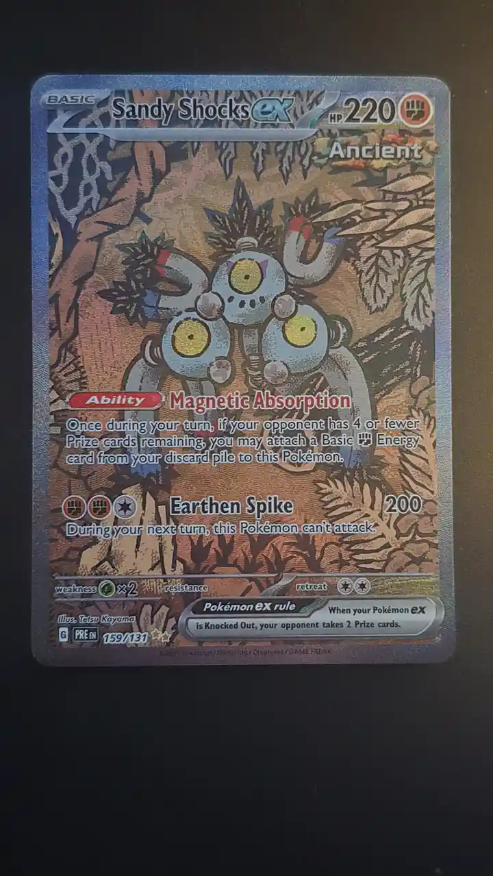 A Pokémon TCG card for 'Sandy Shocks EX' with 220 HP, featuring three robotic, magnet-like creatures with yellow eyes. The…
