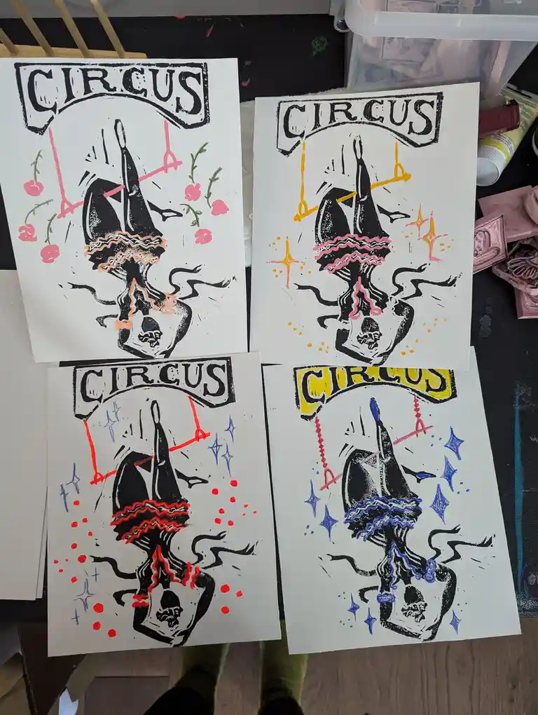 Four identical linocut-style prints of a circus poster featuring a black-and-white illustration of a contortionist or…