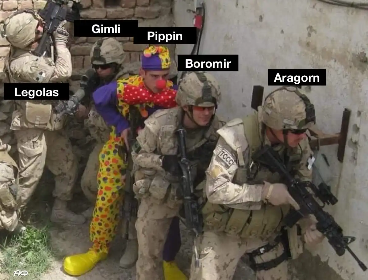 A group of soldiers in camouflage gear and helmets are crouched in a combat stance, holding rifles. One soldier in the…