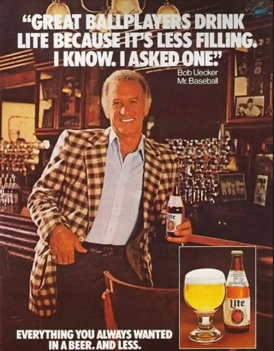 A vintage Miller Lite beer advertisement featuring Bob Uecker, labeled 'Mr. Baseball,' smiling while holding a bottle of…