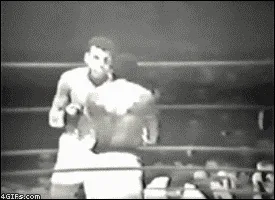six black-and-white stills from a boxing match show a boxer delivering a powerful punch that knocks his opponent down. The…