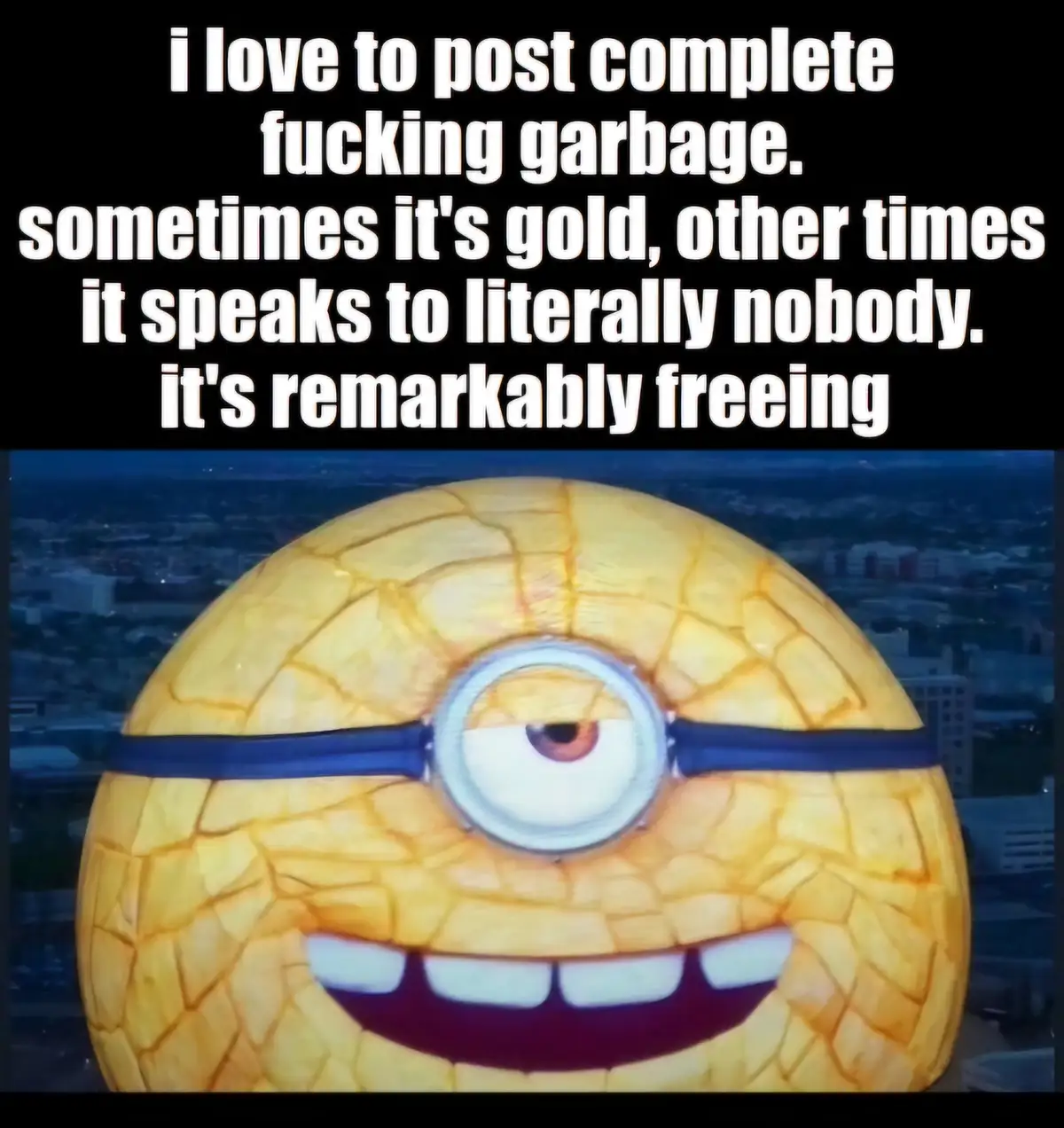 A close-up image of a yellow, one-eyed Minion with a wide, toothy grin, set against a blurred cityscape at dusk. White text…