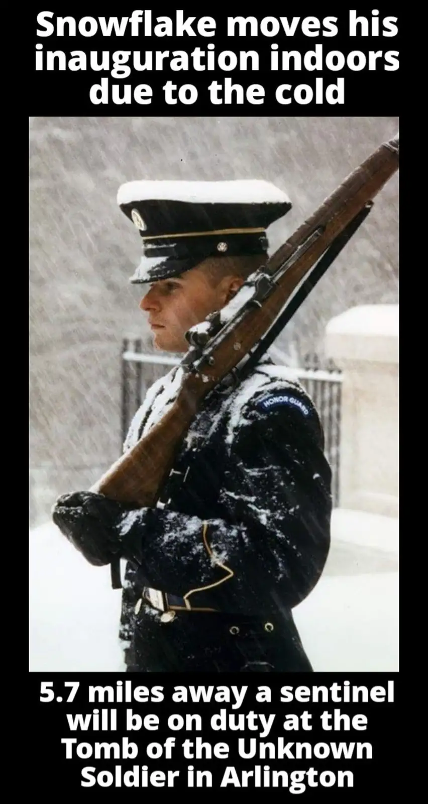 A soldier in a dark uniform and cap, covered in snow, stands at attention holding a rifle outdoors during a heavy snowstorm…