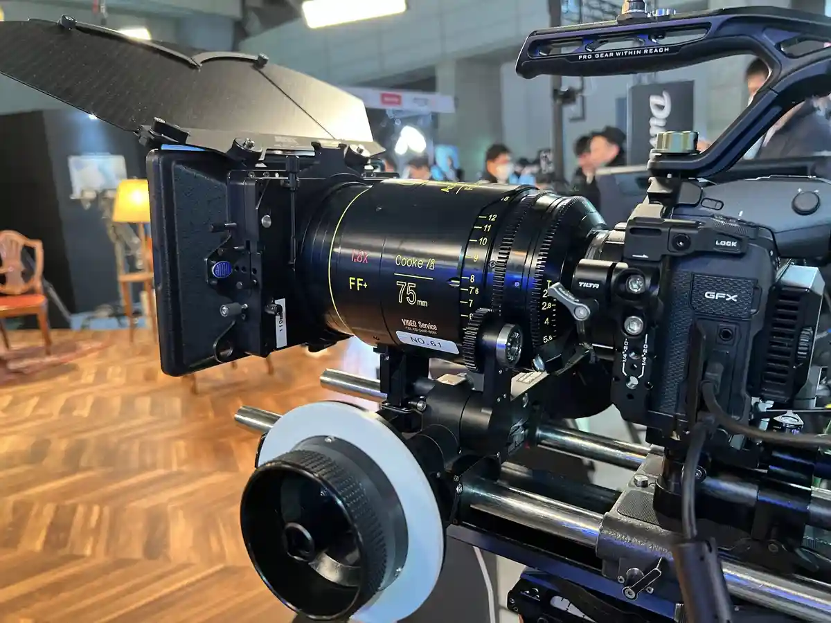 A close-up shot of a professional cinema camera setup, featuring a Cooke S75mm lens mounted on a camera body labeled 'GFX'…