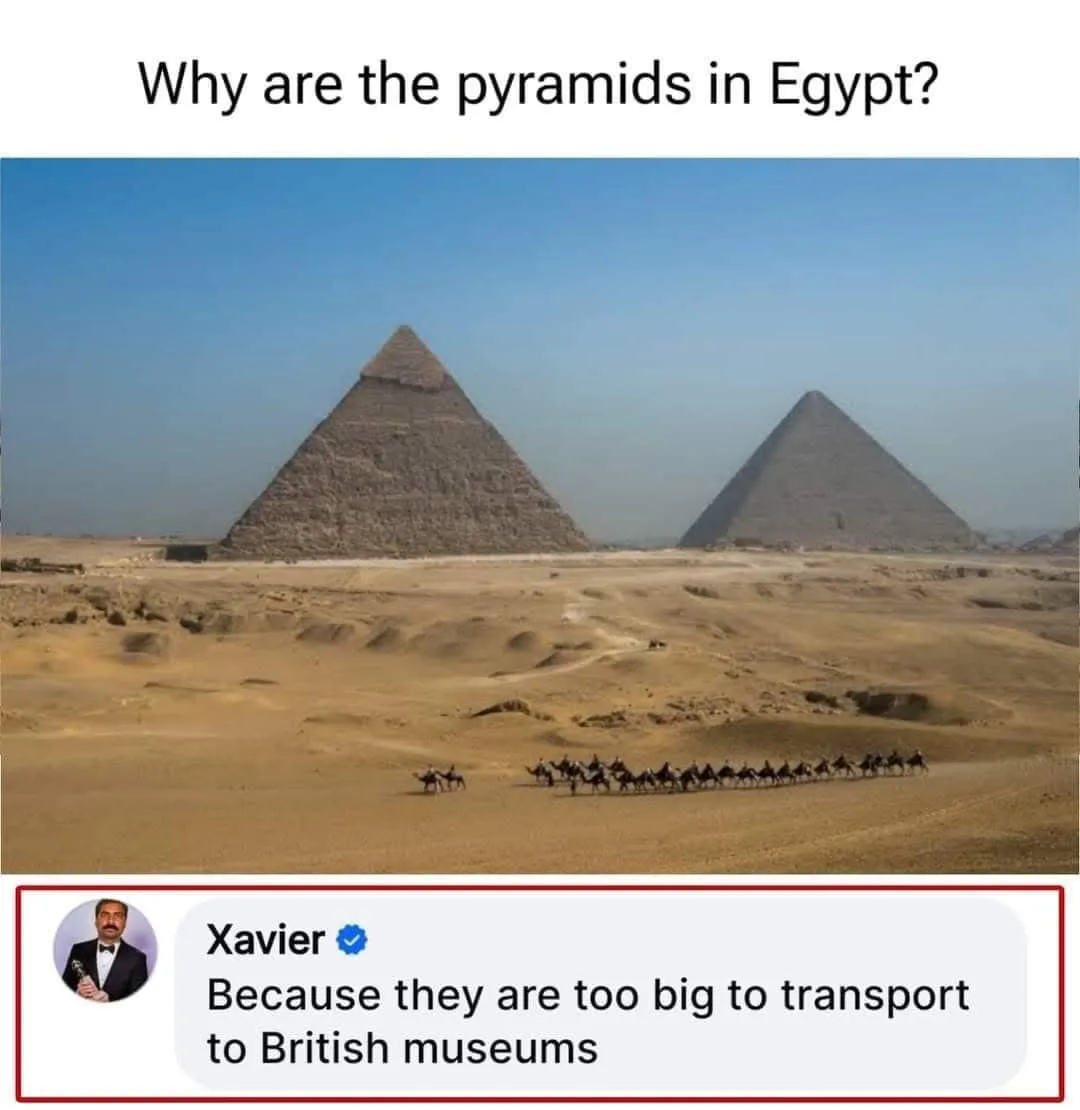 The image shows two large pyramids in a desert landscape under a clear blue sky, with a caravan of camels and riders in the…