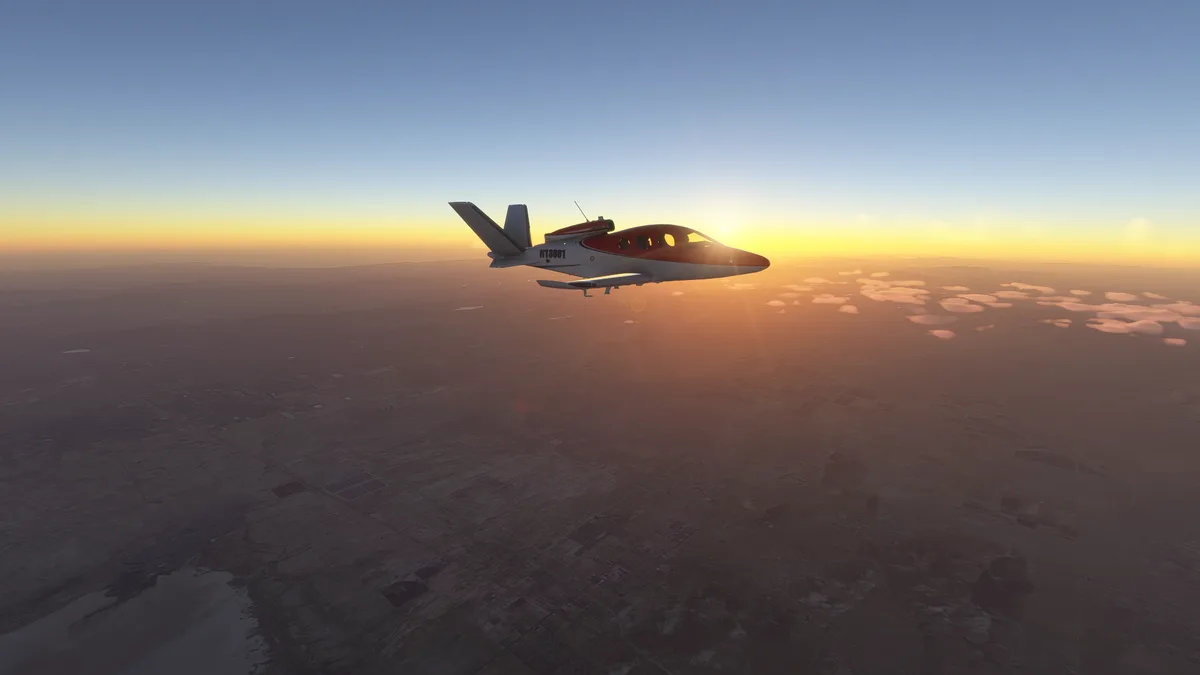 A red and white private jet flies against a sunset sky over a vast, flat landscape with scattered clouds. The overlaid text…