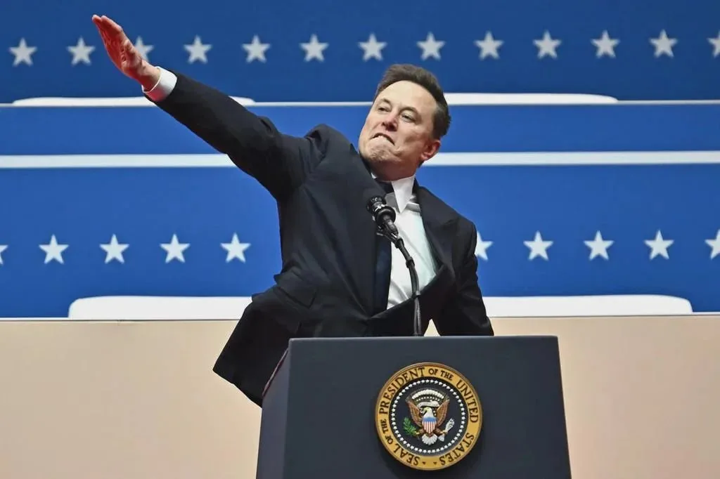 a man in a dark suit stands at a podium with the official seal of the president of the united states, waving his right arm…