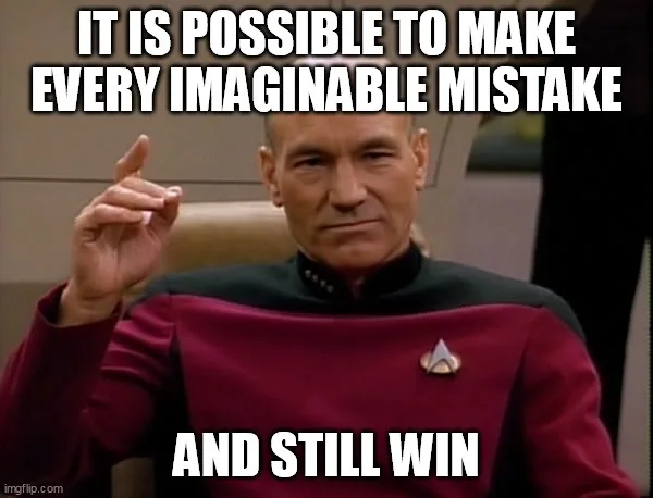 A man in a red Starfleet uniform from Star Trek: The Next Generation, Captain Jean-Luc Picard, sits in a chair with a…