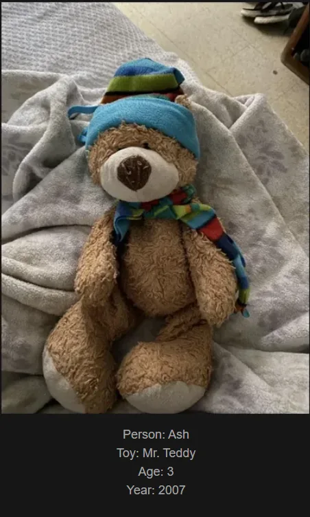 A brown teddy bear wearing a blue striped hat and a colorful scarf sits on a grey blanket. Text overlaid at the bottom…