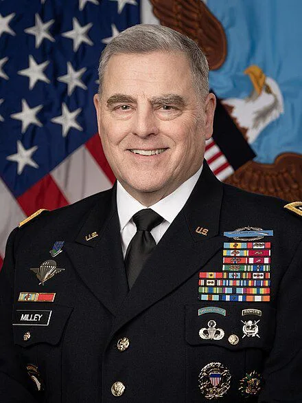A formal military portrait of General Mark Milley in full dress uniform, adorned with numerous medals and insignia, standing…