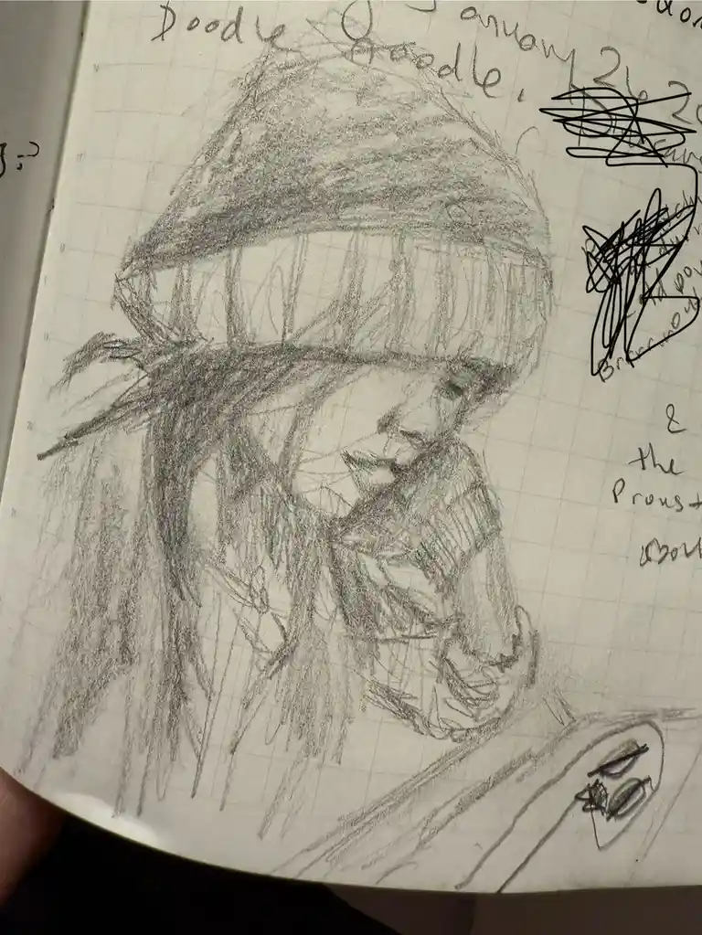 A rough pencil sketch on graph paper shows a person wearing a beanie and scarf, looking down at a phone. The drawing is…