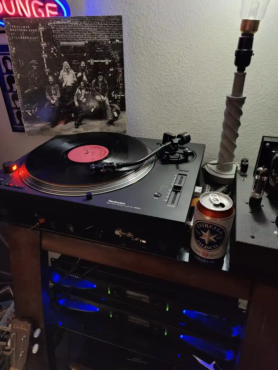 A Technics SL-1200MK7 turntable plays a record with a pink label, with the album cover for 'The Allman Brothers Band at…