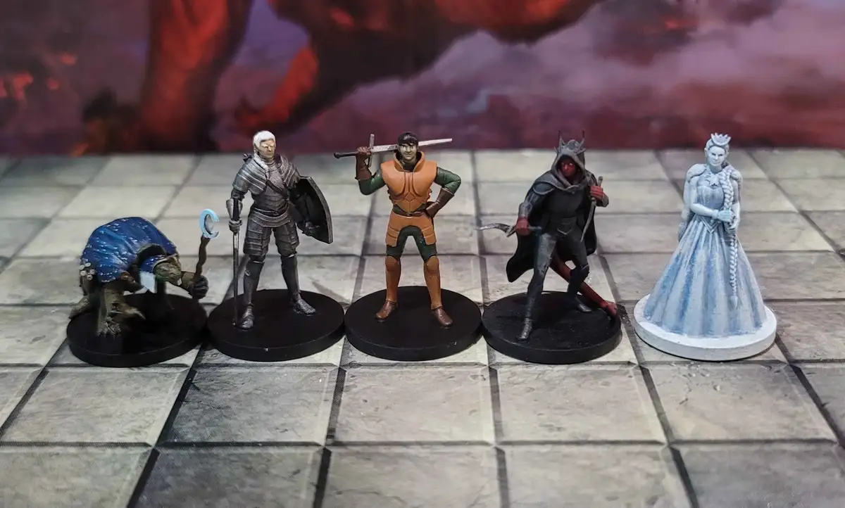 Five painted fantasy miniatures stand in a row on a checkered game board against a fiery backdrop. From left to right: a…