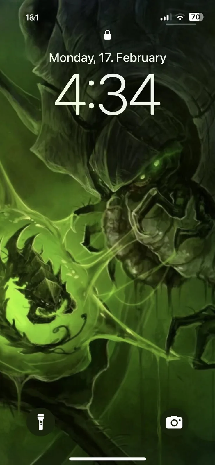 A smartphone lock screen displays the time 4:34 and date Monday, 17. February, overlaid on a dark green, menacing fantasy…
