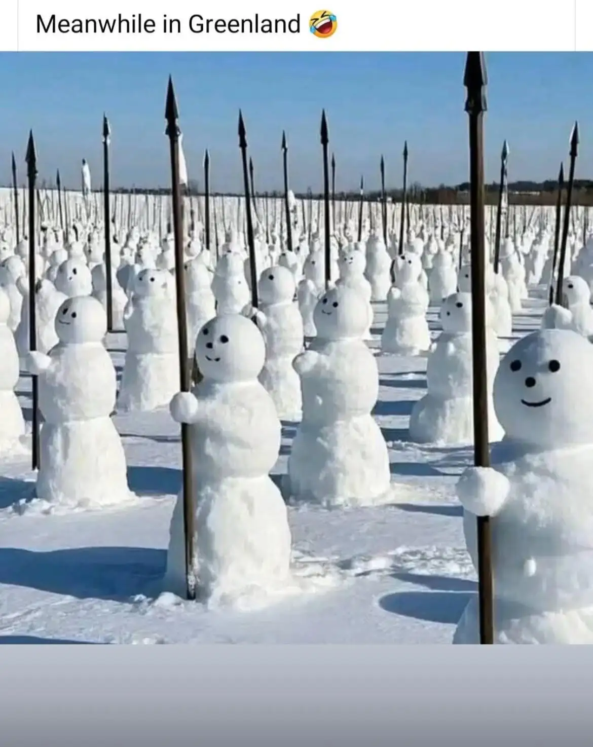 An image shows a vast field of snowmen arranged in rows, each holding a long spear with a pointed tip, under a clear blue…
