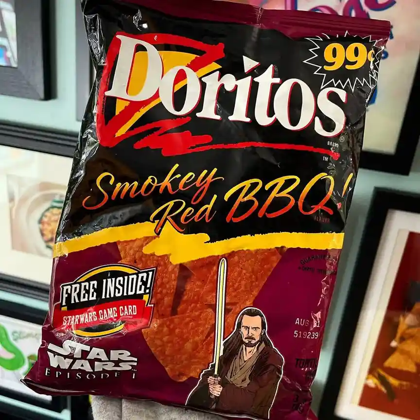 A bag of Doritos Smokey Red BBQ flavor chips features a Star Wars Episode I promotion with a graphic of Qui-Gon Jinn holding…